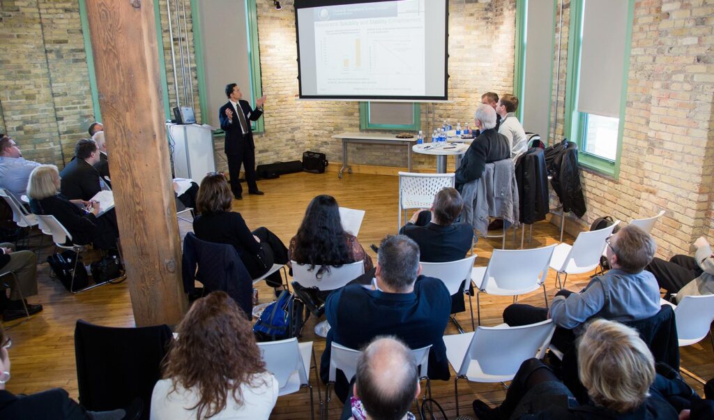 Business pitch event with onlookers